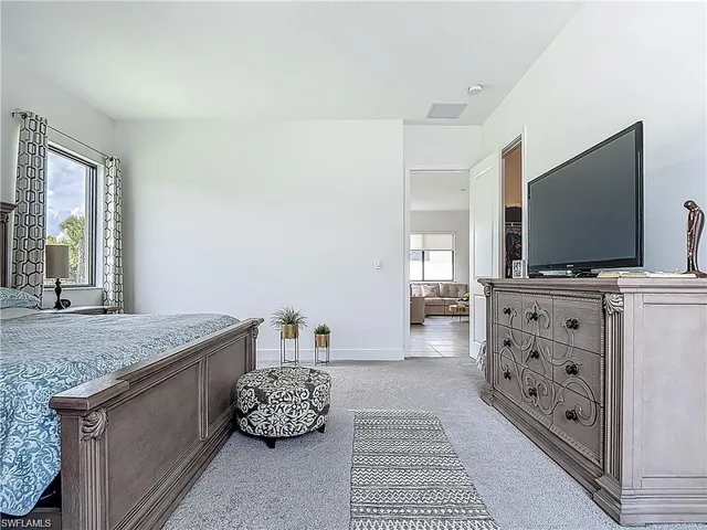 a bedroom with a bed and a dresser