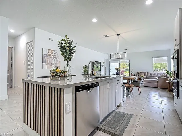a kitchen with counter space dining table and chairs
