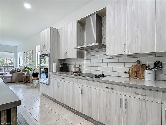 a kitchen with stainless steel appliances granite countertop a sink dishwasher stove and cabinets