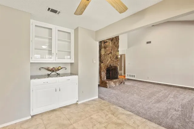 a kitchen with granite countertop white cabinets and white appliances