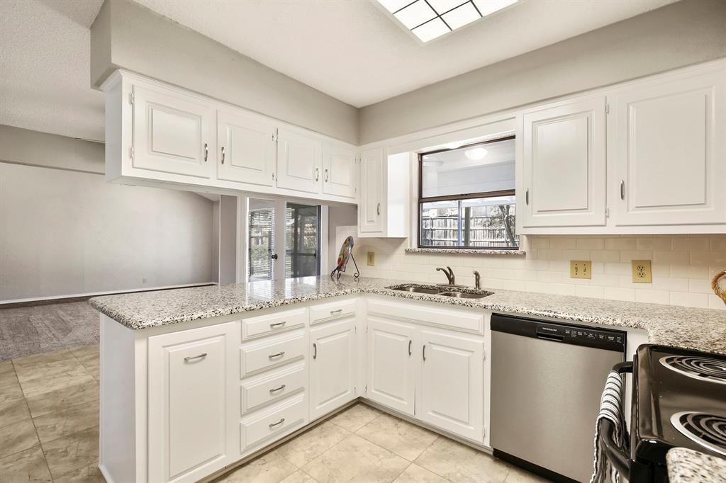 1916 Everglade Court Grapevine, TX 76051 - Photo 13 of 35 a kitchen with granite countertop white cabinets and white appliances