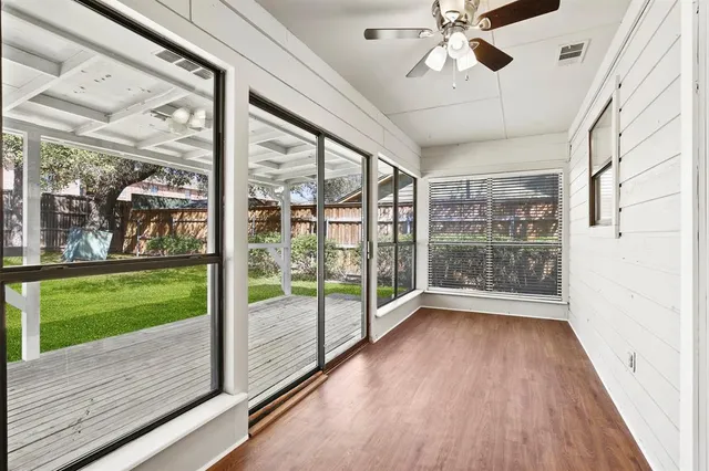 a view of an entryway with wooden floor and door