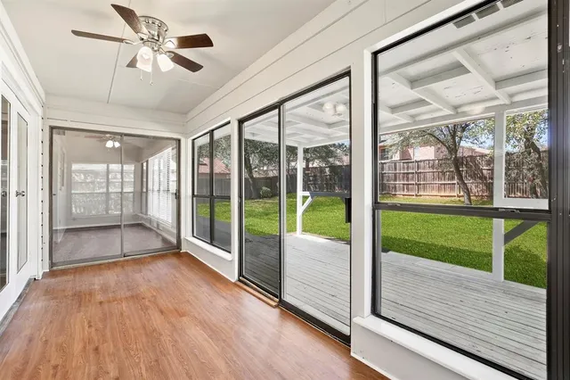 a view of an empty room with a chandelier fan