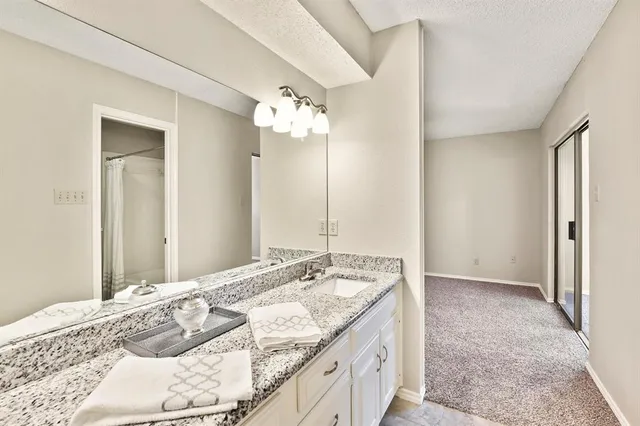 a view of an empty room with closet and a window