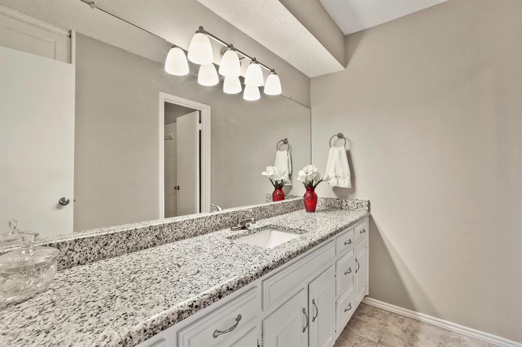 1916 Everglade Court Grapevine, TX 76051 - Photo 29 of 35 a bathroom with a granite countertop sink and a mirror