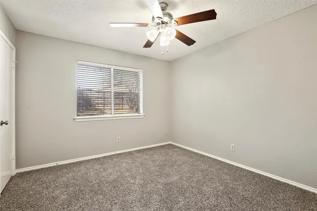 a front view of a house with a garden and trees