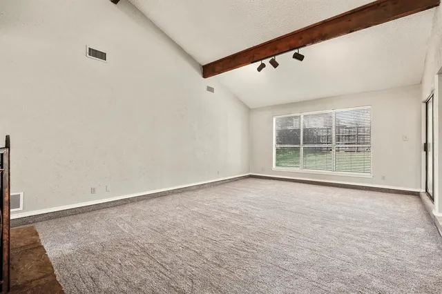 a view of an empty room with a fireplace
