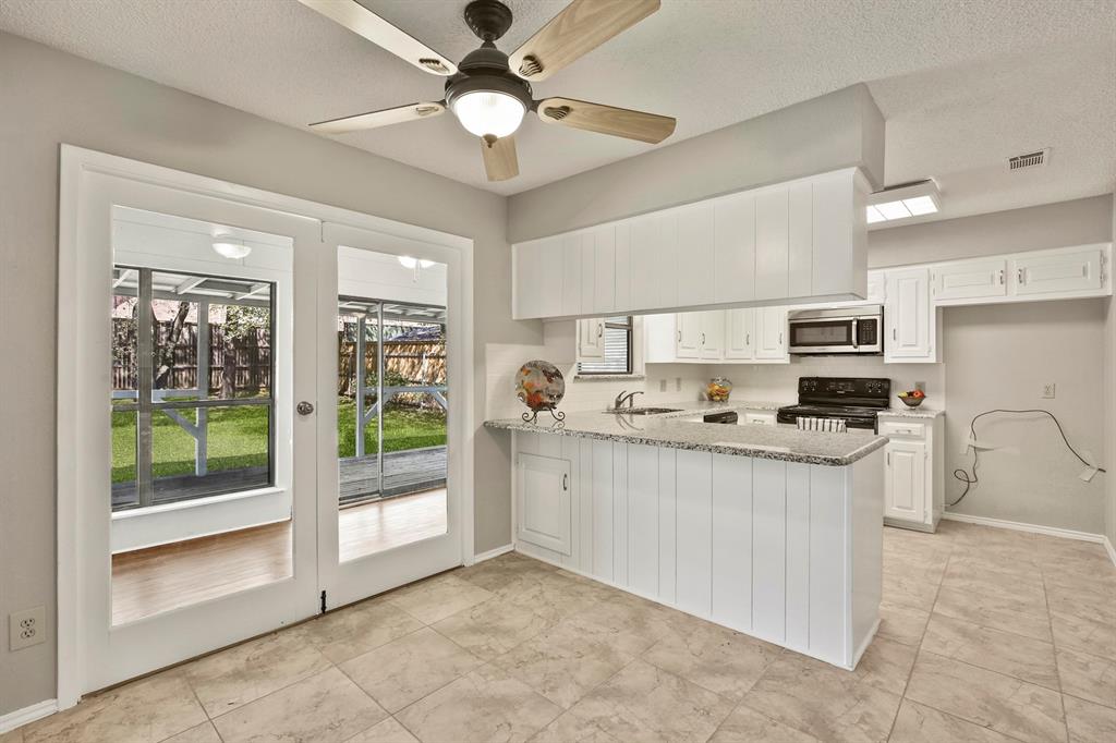 1916 Everglade Court Grapevine, TX 76051 - Photo 9 of 35 a kitchen with stainless steel appliances granite countertop a stove oven and a refrigerator with white cabinets