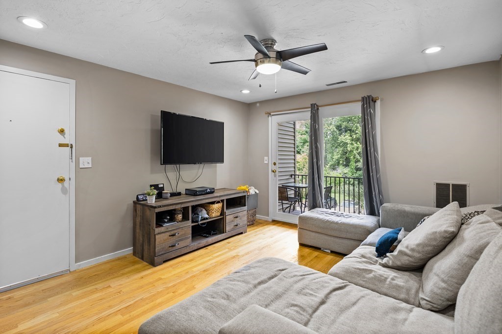 189 Littleton Road, Unit 44 Chelmsford, MA 01824 - Photo 1 of 20 a living room with furniture and a flat screen tv