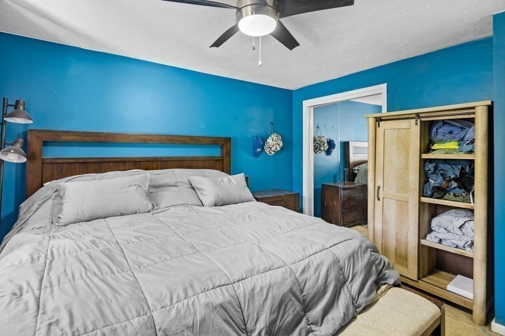 189 Littleton Road, Unit 44 Chelmsford, MA 01824 - Photo 11 of 20 a bedroom with a large bed and a chandelier