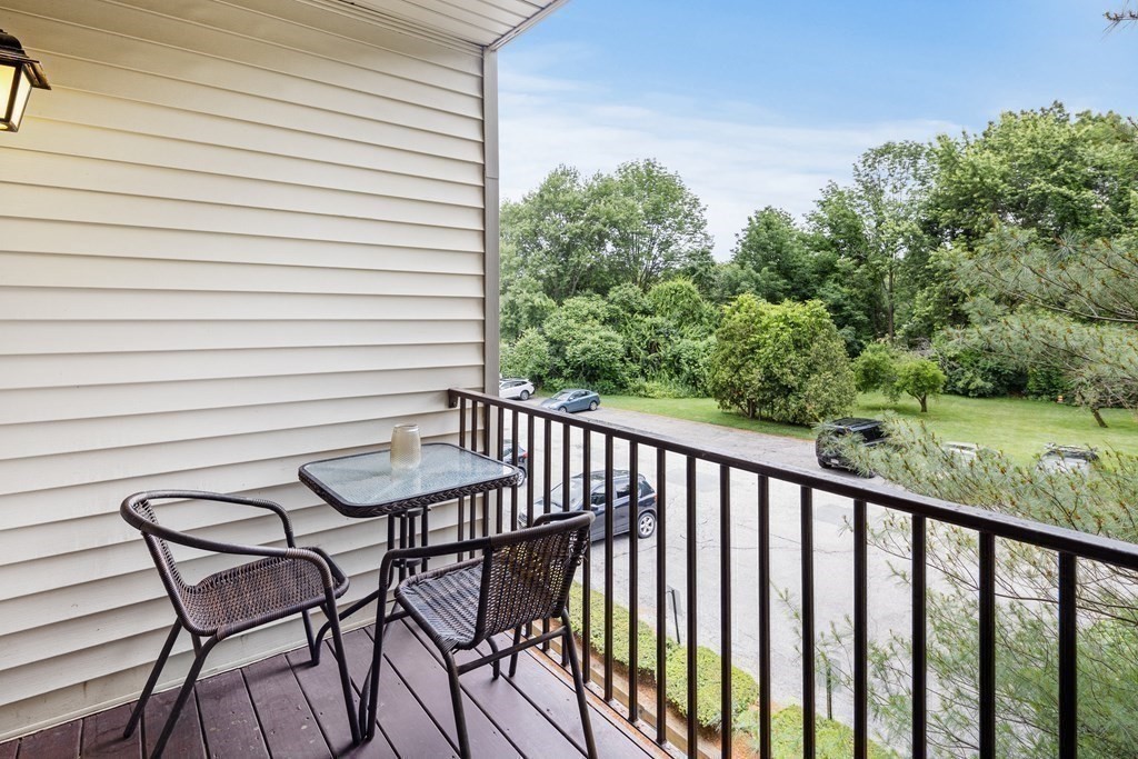 189 Littleton Road, Unit 44 Chelmsford, MA 01824 - Photo 15 of 20 a view of a chair and tables in the balcony