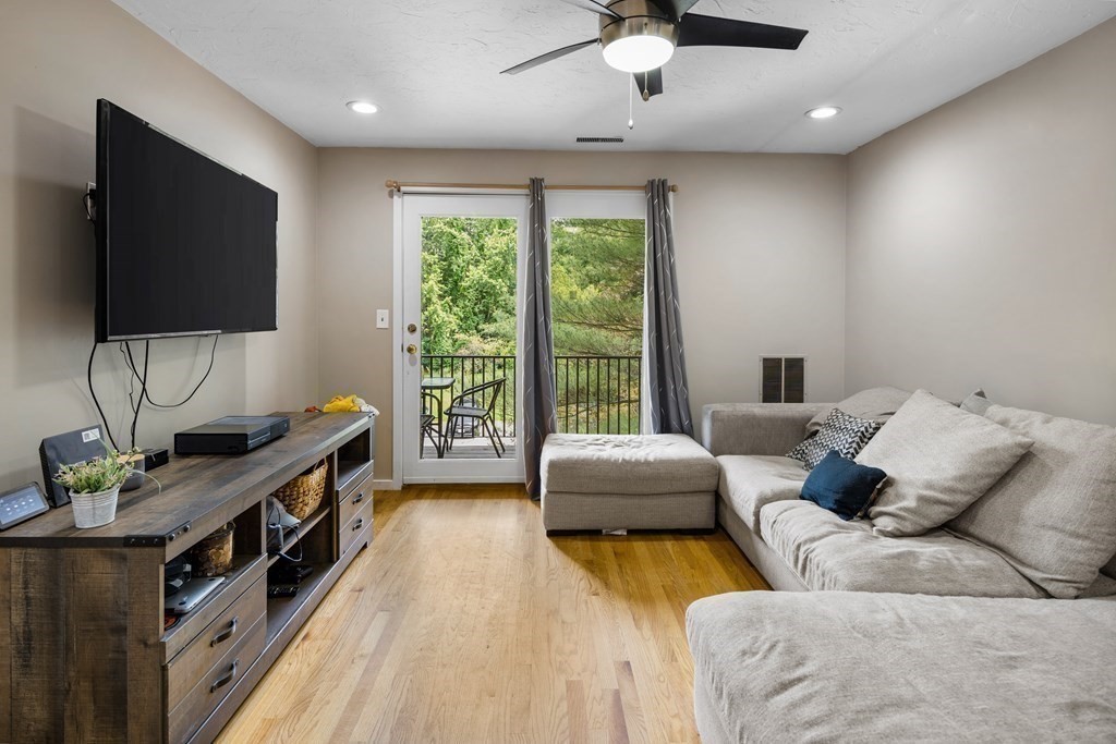 189 Littleton Road, Unit 44 Chelmsford, MA 01824 - Photo 2 of 20 a living room with furniture and a flat screen tv