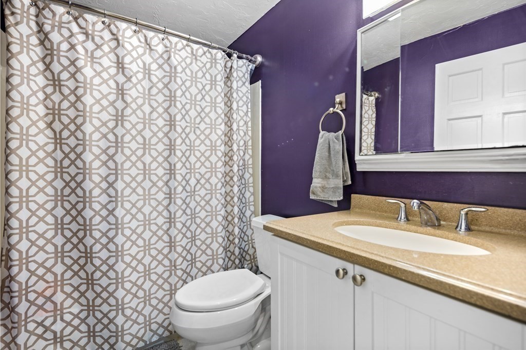 189 Littleton Road, Unit 44 Chelmsford, MA 01824 - Photo 7 of 20 a bathroom with a sink toilet and mirror