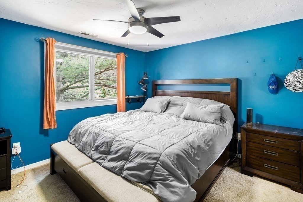 189 Littleton Road, Unit 44 Chelmsford, MA 01824 - Photo 9 of 20 a bed sitting in a bedroom next to a window