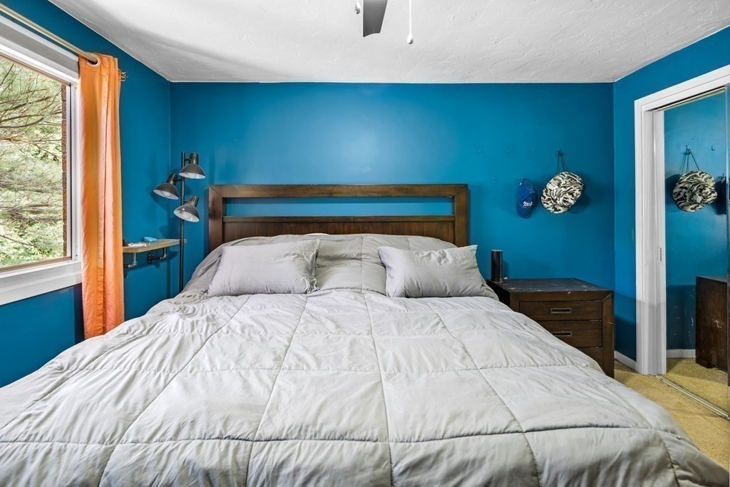 189 Littleton Road, Unit 44 Chelmsford, MA 01824 - Photo 10 of 20 a large bed sitting in a bedroom next to a window