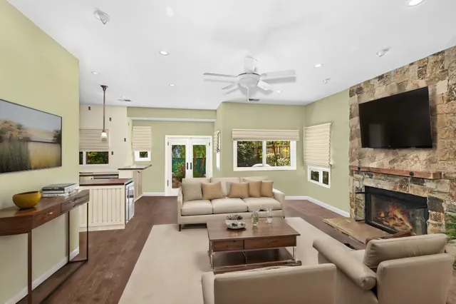 a living room with furniture fireplace and flat screen tv