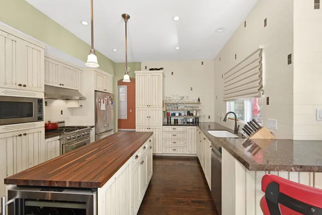 a kitchen with stainless steel appliances a stove sink and cabinets