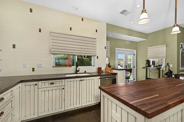 a kitchen with stainless steel appliances granite countertop a sink and cabinets