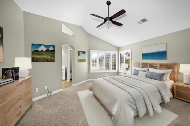 a bedroom with a large bed and a flat screen tv
