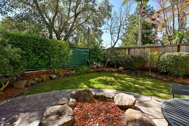 a view of a backyard with sitting area