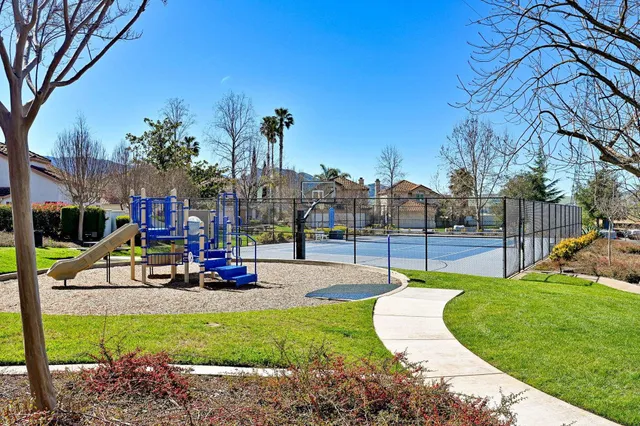 a view of a lush green hillside and a houses