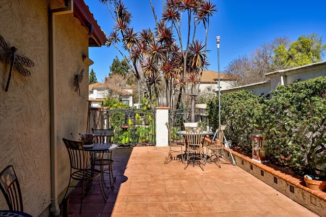 a view of a patio with table and chairs and potted plants