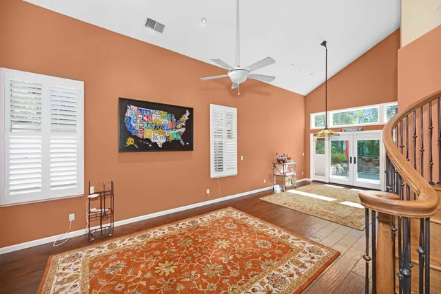 a view of a bedroom with wooden floor and a window
