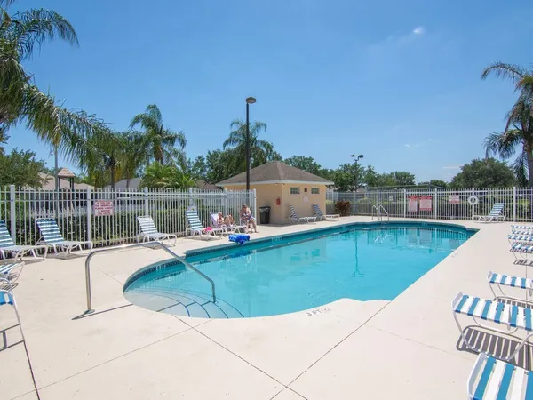 a view of a swimming pool with a lounge chair