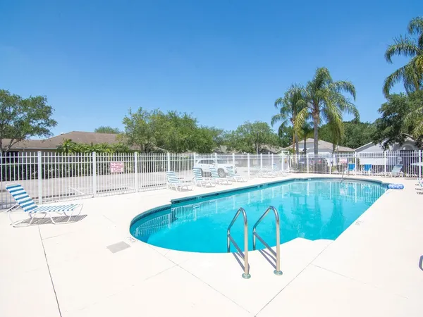 a view of a swimming pool with a lounge chair