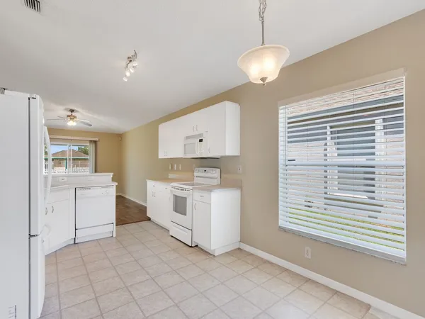 a kitchen with a stove a sink and a refrigerator