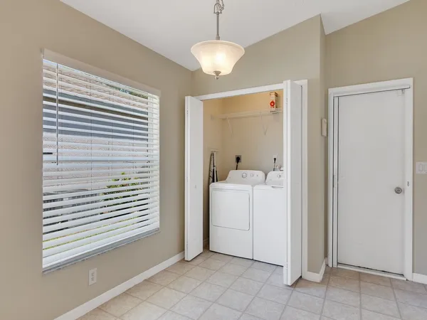 a view of a storage & utility room with a window