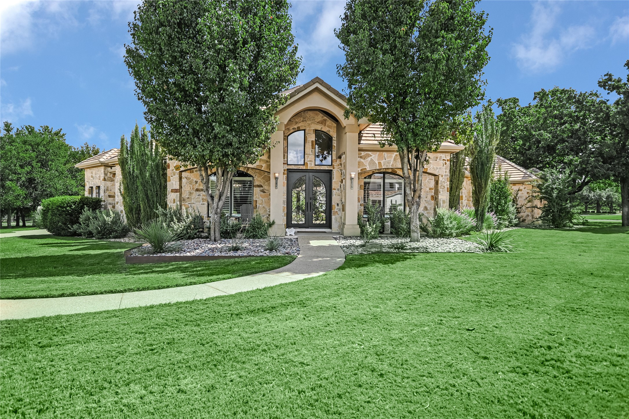 100 Dovetail Lane Georgetown, TX 78628 - Photo 2 of 34 Inviting walkway to your custom stone and stucco construction built home.