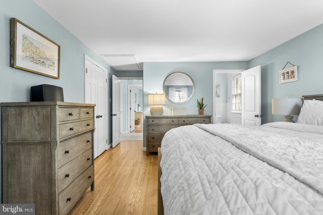 a bed room with a bed and mirror