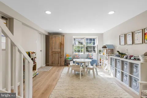 a living room with furniture and a dining table with rug floor