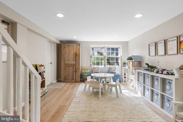 a living room with furniture and a dining table with rug floor