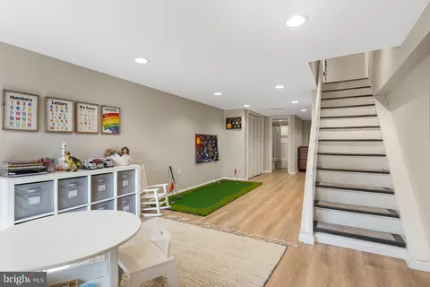 a room with furniture and a view of kitchen