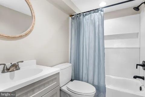 a white toilet sitting next to a bathroom sink