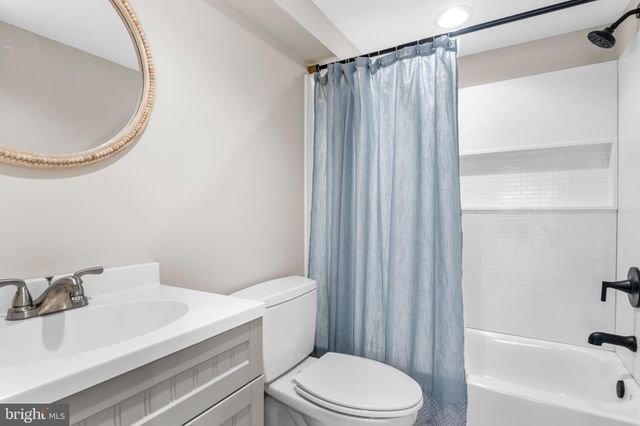 a white toilet sitting next to a bathroom sink