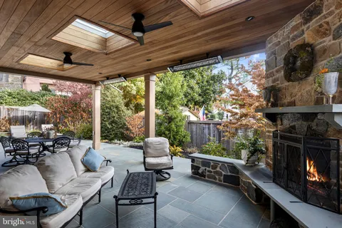 a living room with patio furniture and a fireplace