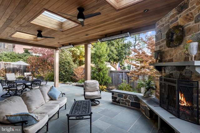 a living room with patio furniture and a fireplace