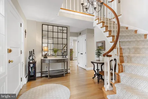 a view of entryway dining room and hall with wooden floor