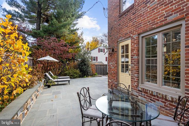 a view of a patio with table and chairs and potted plants