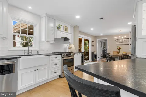 a kitchen with stainless steel appliances granite countertop a stove refrigerator sink and cabinets