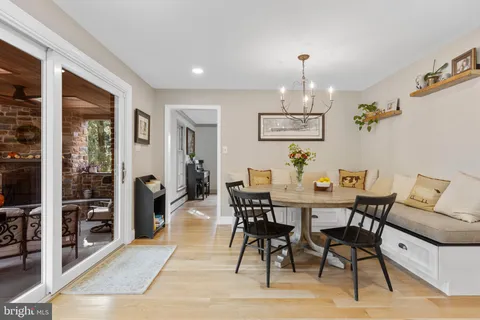 a view of a dining room with furniture and chandelier