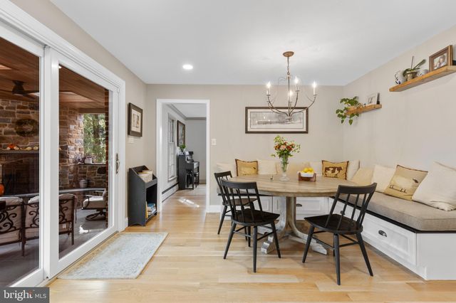 a view of a dining room with furniture and chandelier