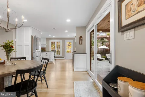 a dining room with furniture and wooden floor