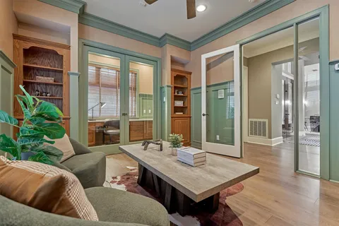 a living room with furniture and a chandelier