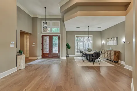 a living room with furniture a large window and a fireplace