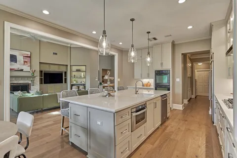 a kitchen with sink stove and refrigerator
