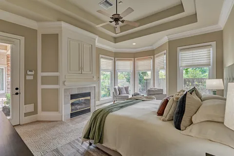 a bedroom with a large bed and a chandelier